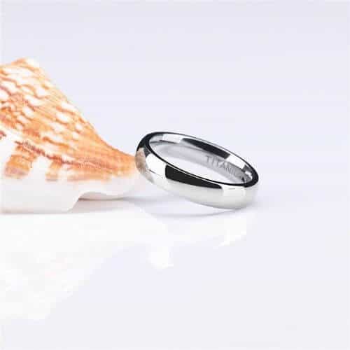 Silver titanium ring rests against shell